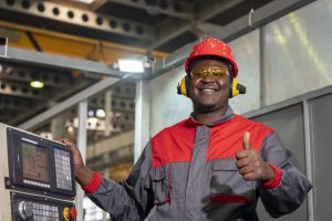 Machine Operator In Red Helmet