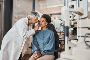 Optician checking eyesight of a patient