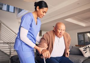 man in wheelchair and support in nursing home for medical service