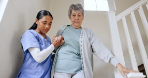 Senior woman, nurse and help on stairs